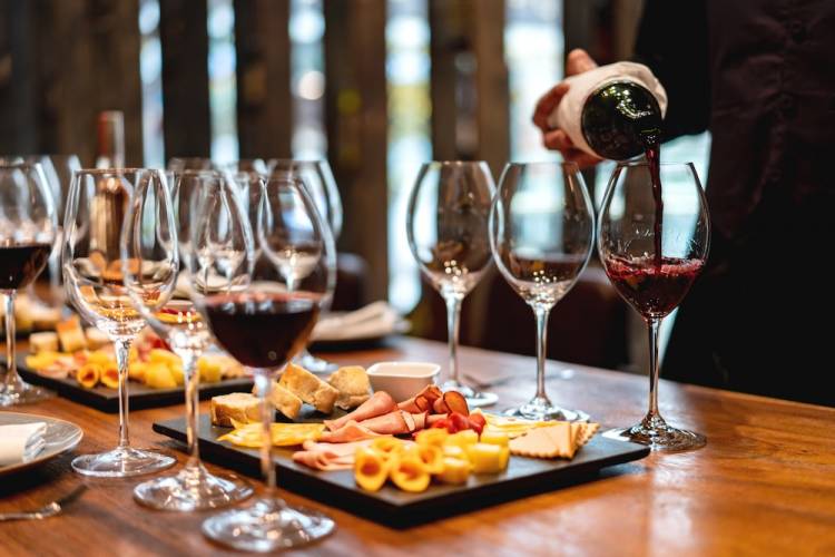 person pouring wine tastings at a food and wine festival